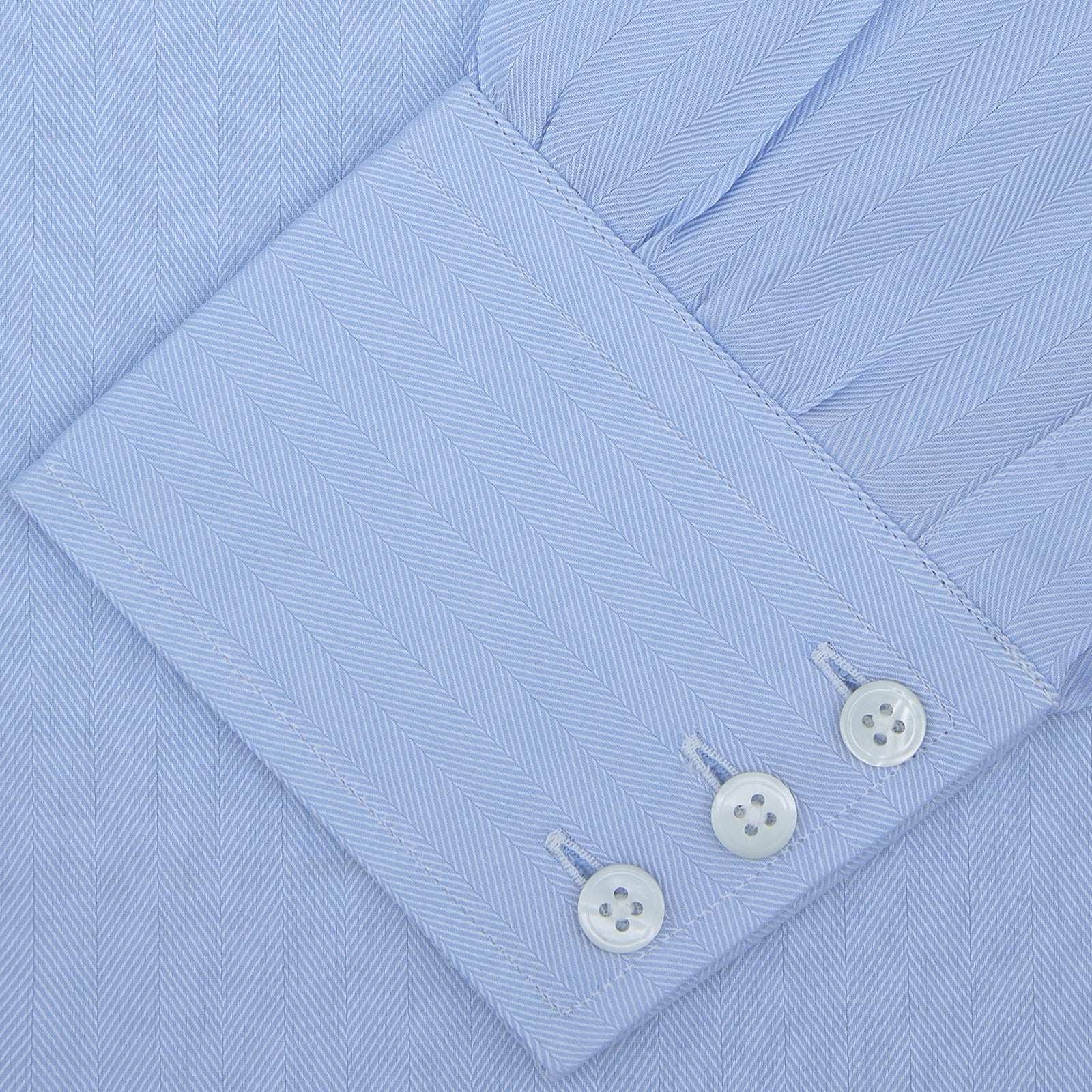 View 2 of product The Turnbull & Asser Light Blue Herringbone Superfine Cotton Shirt features a T&A collar and 3-button cuffs, elegantly displayed against a plain white background.