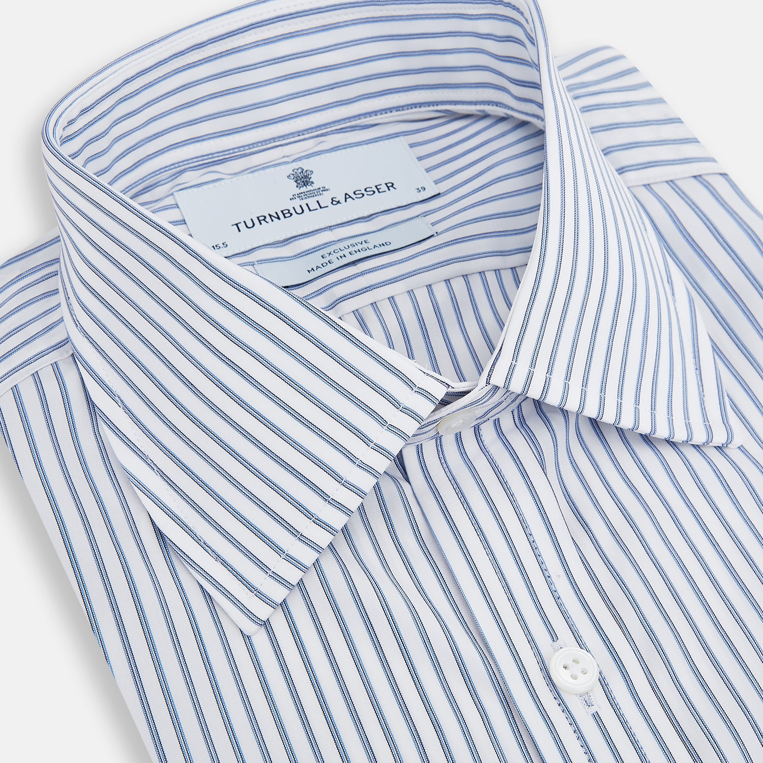 View 2 of product The Turnbull & Asser Navy Double Pinstripe Mayfair Shirt is a long-sleeve, button-up collared shirt with thin vertical blue and white stripes, shown against a plain white background.