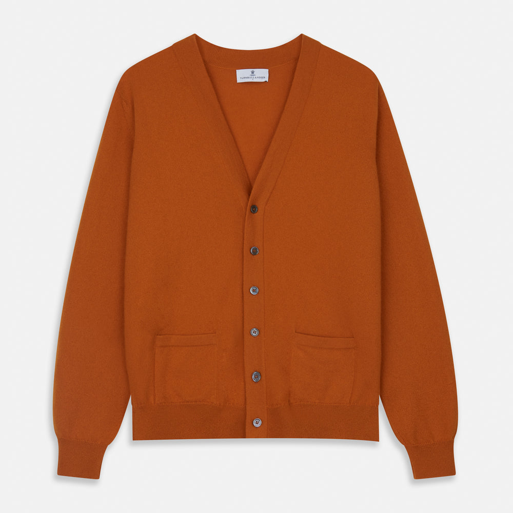 The Rust Lachlan Cashmere Cardigan by Turnbull & Asser features a V-neck, long sleeves, front button closure, and two front pockets—ideal for layering in smart-casual looks. Shown laid flat on a plain white background.