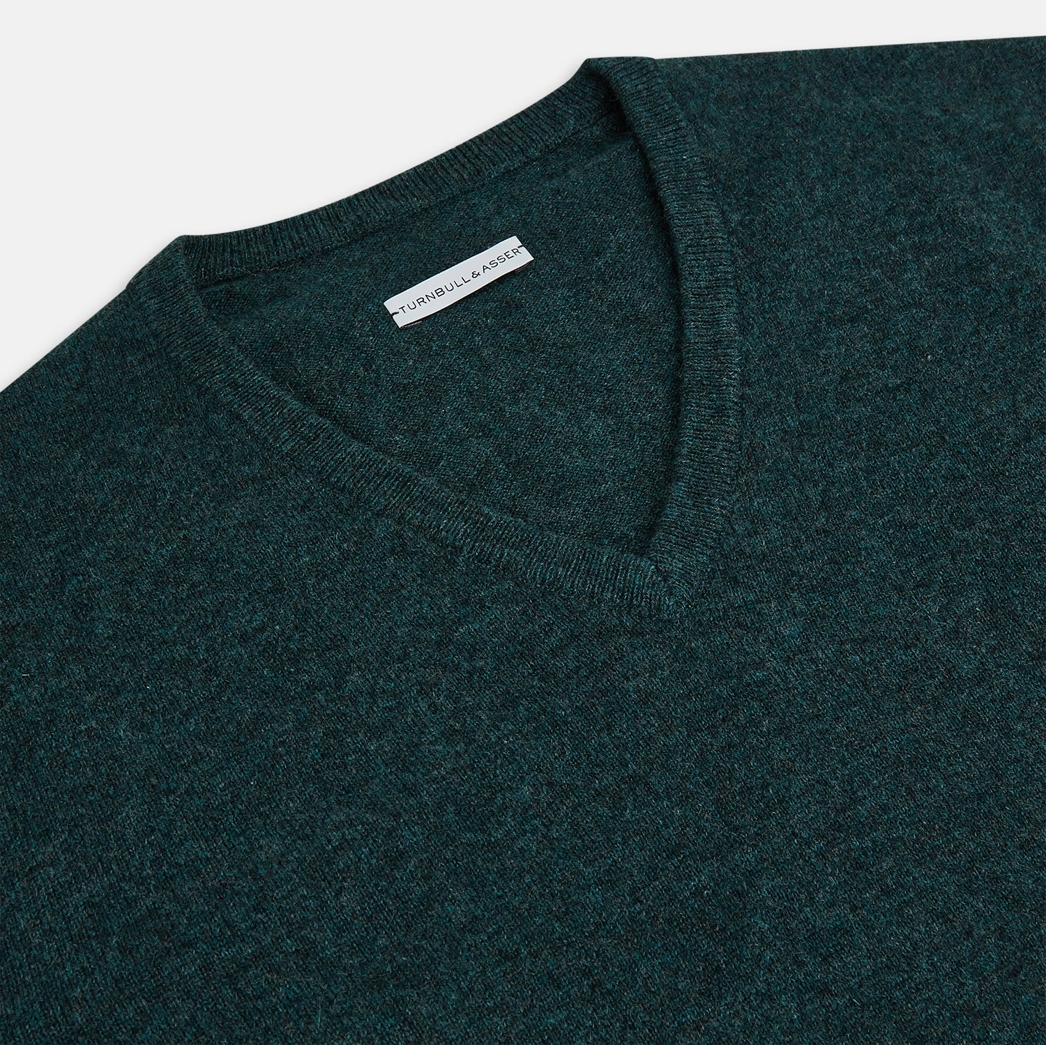 View 2 of product The Turnbull & Asser Forest Green Cashmere V-Neck Jumper features long sleeves, ribbed cuffs, collar, and hem. Shown against a white background, it's a classic knitwear piece ideal for layering.