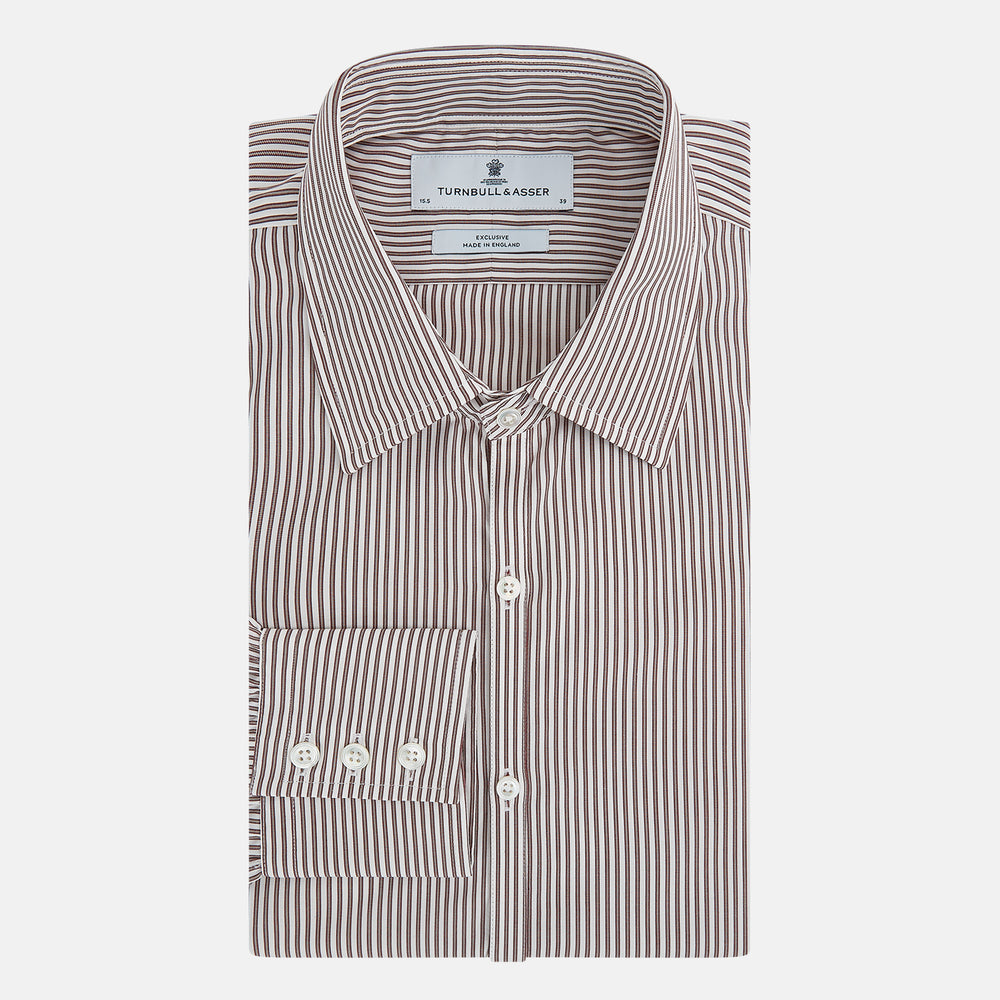 The Burgundy Halo Stripe Westminster Shirt by Turnbull & Asser features long sleeves, a button-up front, a Westminster collar, and thin vertical brown and white stripes, shown on a plain white background.