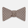 View 1 of product The Turnbull & Asser Navy and Taupe Micro Dot Silk Bow Tie features a grid pattern with small dots, shown against a plain white background.