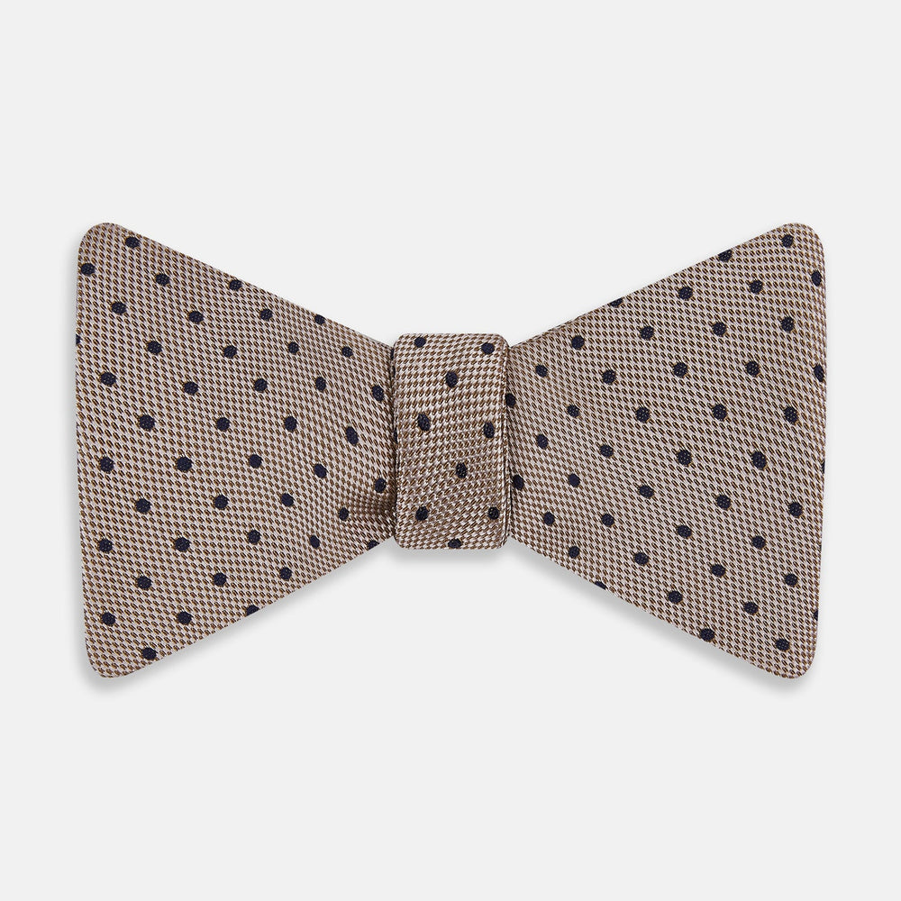 The Turnbull & Asser Navy and Taupe Micro Dot Silk Bow Tie features a grid pattern with small dots, shown against a plain white background.
