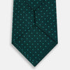 View 3 of product The Turnbull & Asser Blue and Forest Green Micro Dot Silk Tie features small light blue polka dots, rolled up against a white background—an elegant men’s accessory for any occasion.