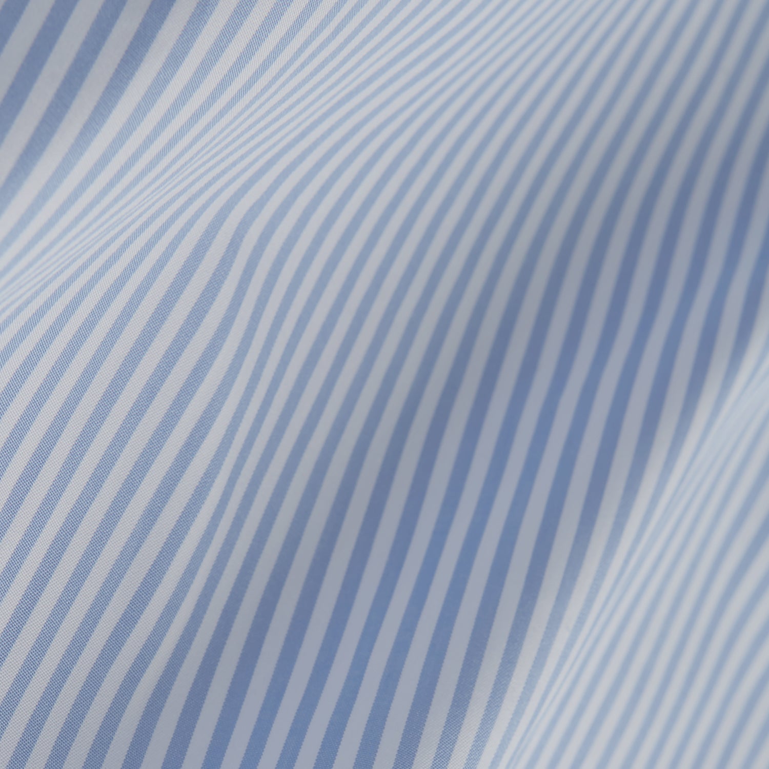 View 6 of product The Turnbull & Asser Light Blue Bengal Stripe Shirt features a classic T&A collar and 3-button cuffs, showcasing subtle British style in crisp white pinstripes, shown laid flat on a white background.