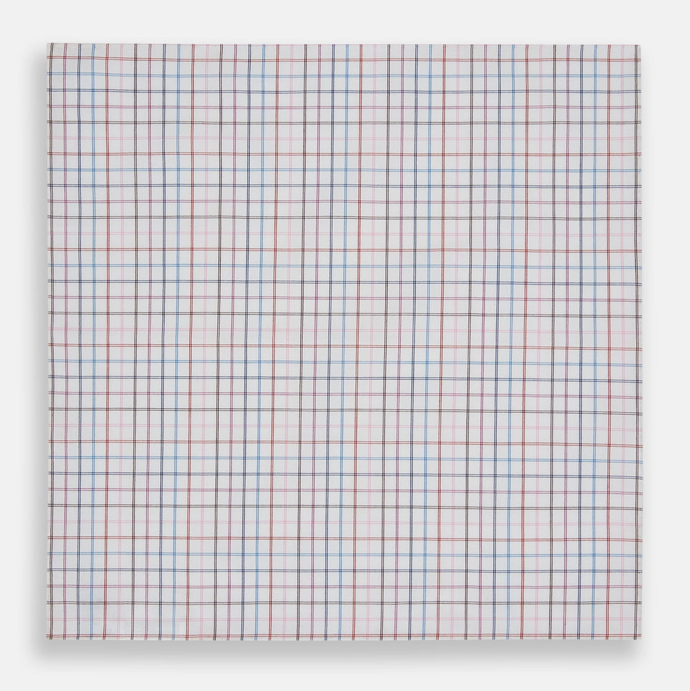 The Turnbull & Asser Hand Rolled Multi Graph Check Handkerchief features a white cotton base with thin red, blue, and purple intersecting lines forming a check pattern, neatly folded with stitched edges for an elegant gentleman's accessory.