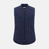 View 1 of product The Turnbull & Asser Navy and Purple Plaid Check Padded Gilet is sleeveless, has a front zipper, two zippered side pockets, a small chest pocket, and is shown on a plain white background.