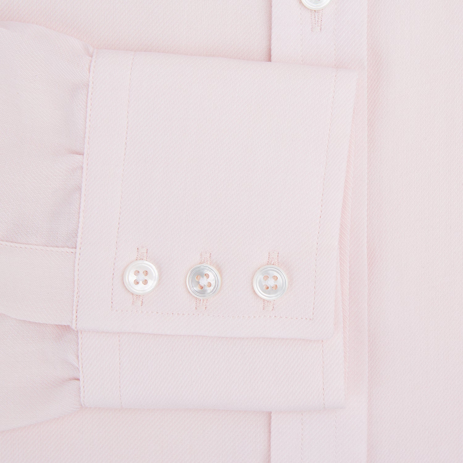 View 4 of product The Pale Pink Cotton Cashmere Mayfair Shirt by Turnbull & Asser features a classic collar, button-down front, and buttoned cuffs, crafted from a luxurious cotton-cashmere blend and displayed flat on a white background.
