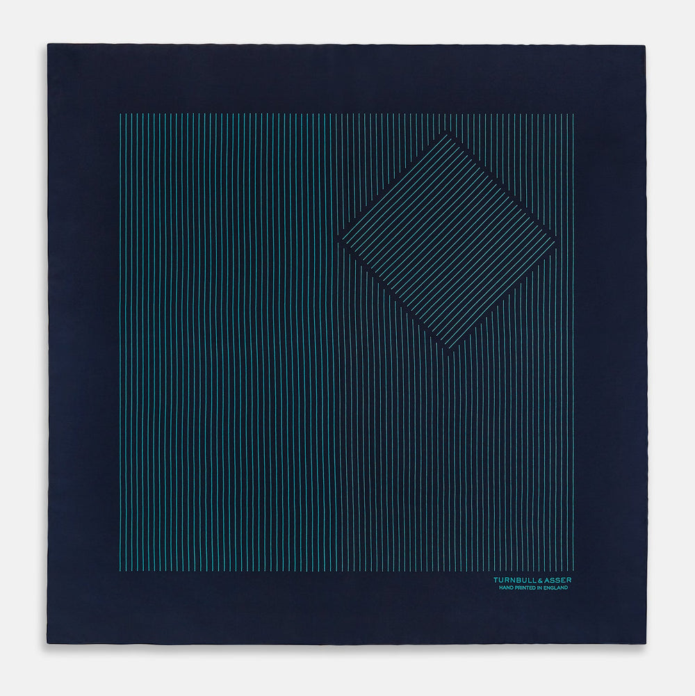 A Navy and Petrol Green Stripe Silk Pocket Square by Turnbull & Asser, featuring thin petrol green stripes and "Turnbull & Asser Hand Printed in England" in the bottom right corner. One corner is folded to display hand-rolled edges.