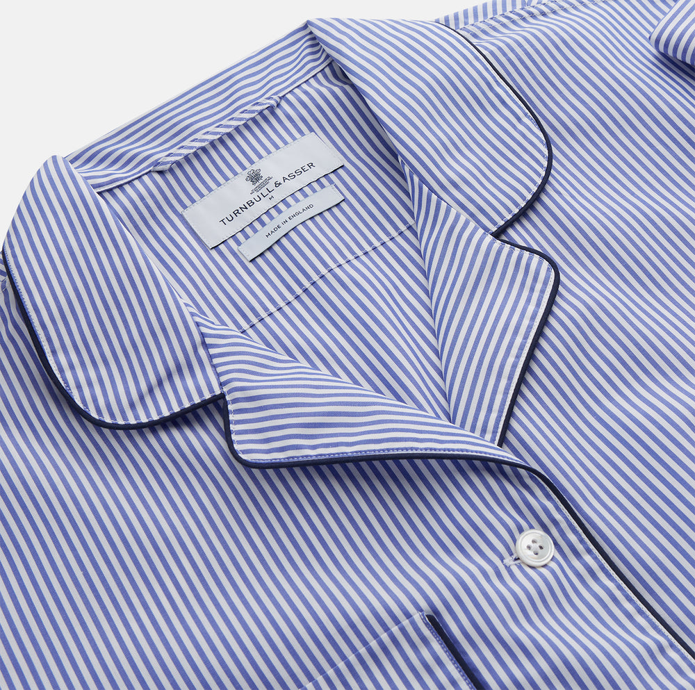 The Turnbull & Asser Women's Harriet Blue Bengal Stripe Pyjama Set features premium cotton, a long-sleeve button-up top with chest pocket, and drawstring pants—an ideal gift option.