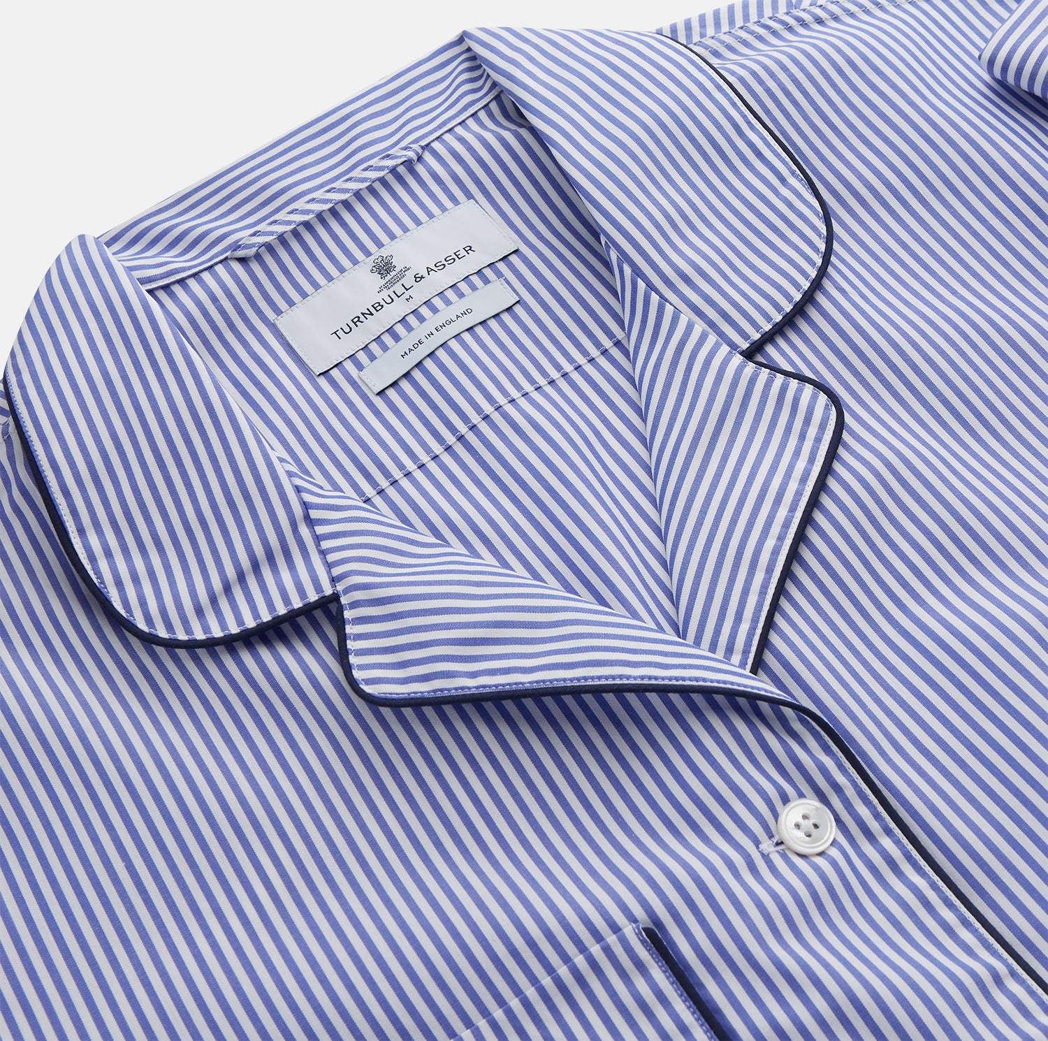 View 3 of product The Turnbull & Asser Women's Harriet Blue Bengal Stripe Pyjama Set features premium cotton, a long-sleeve button-up top with chest pocket, and drawstring pants—an ideal gift option.