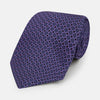 View 1 of product The Turnbull & Asser Purple Square and Circle Silk Tie is crafted from fine English silk, showcasing a purple design with a repeating geometric pattern of squares and circles for a refined, elegant look.