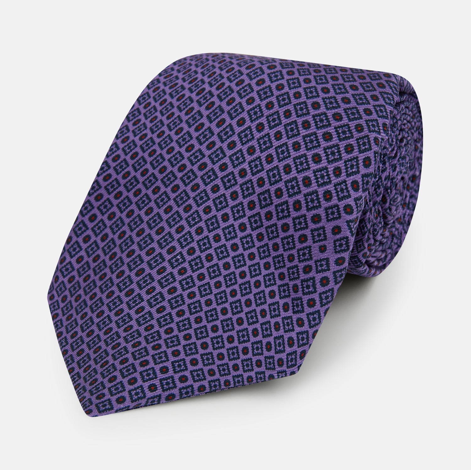 View 1 of product The Turnbull & Asser Purple Square and Circle Silk Tie is crafted from fine English silk, showcasing a purple design with a repeating geometric pattern of squares and circles for a refined, elegant look.