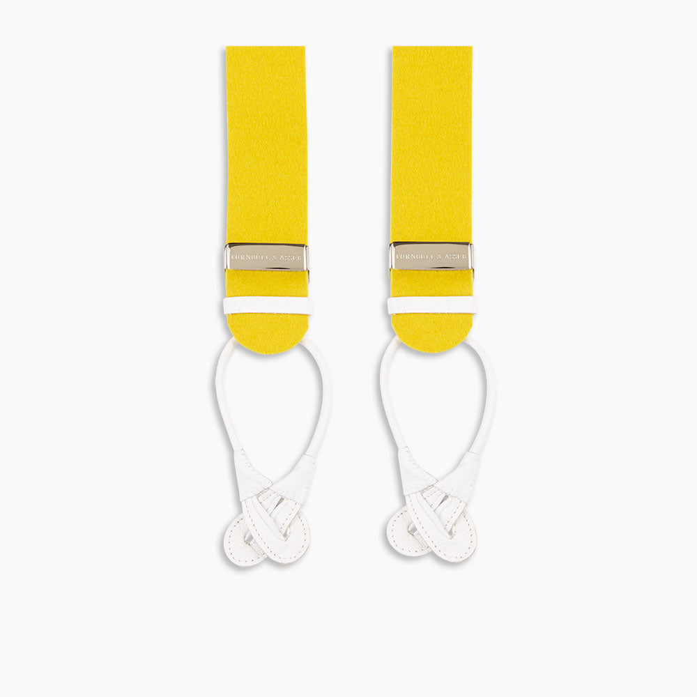The Turnbull & Asser Golden Adjustable Felt Braces feature yellow elastic, silver metal clips, and white leather loops, evoking classic English style. Shown against a white backdrop.
