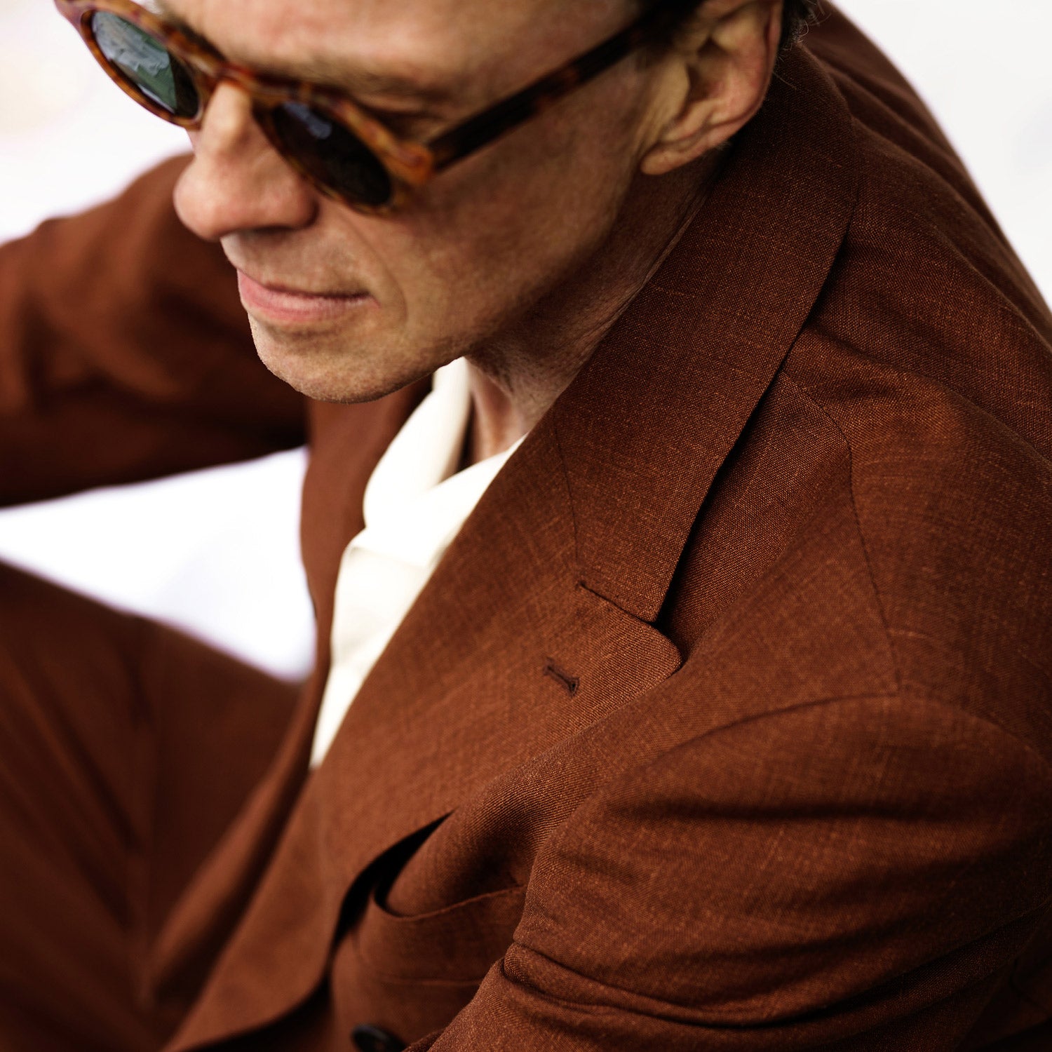 View 5 of product The Turnbull & Asser Rust Linen-Wool-Silk Bertie Blazer is a red double-breasted jacket with peak lapels, black buttons, and flap pockets, tailored in Italy from a luxury linen-wool-silk blend and shown on a white background.