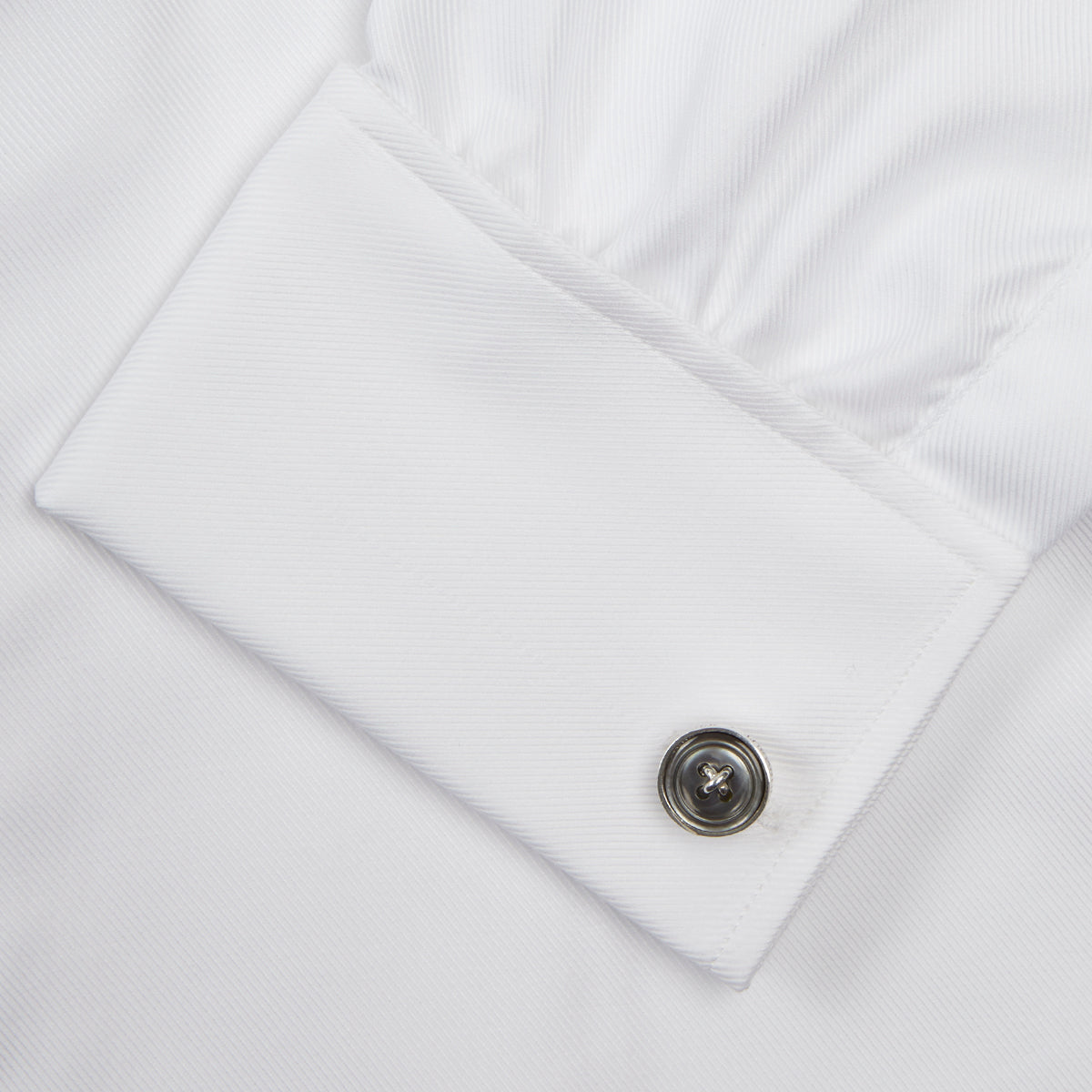 View 6 of product A neatly folded Turnbull & Asser White Oxford Shirt with T&A collar and double cuffs is displayed on a light blue background.