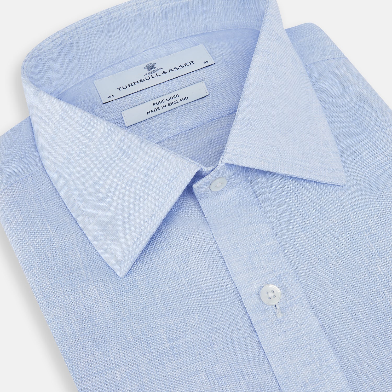 View 2 of product The Turnbull & Asser Pale Blue Linen Mayfair Shirt features a collar, front pocket, and white buttons. This long-sleeve shirt is displayed on a white background.