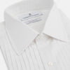 View 2 of product The Turnbull & Asser White Pleated Cotton Dress Shirt features a T&A collar, double cuffs, a button-down front, elegant chest pleats, and a slightly curved hem for a classic formal look.