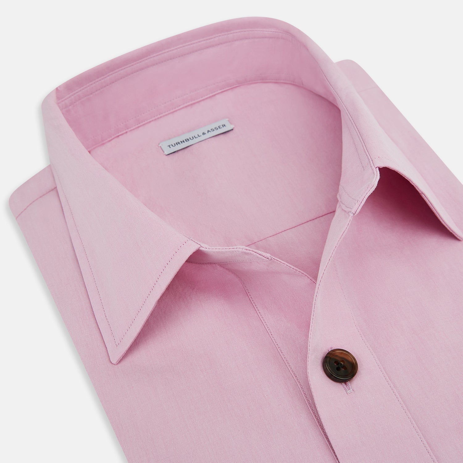 View 2 of product The Pink Hyde Overshirt by Turnbull & Asser is a long-sleeved, light pink sanforised cotton shirt with a left chest pocket and dark buttons—an elegant, laid-back alternative to a blazer.
