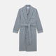 The Turnbull & Asser Green and Blue Stripe Cotton Arnold Gown features long sleeves, a knee-length cut, a shawl collar, front pockets, and an elegant wrap belt at the waist.