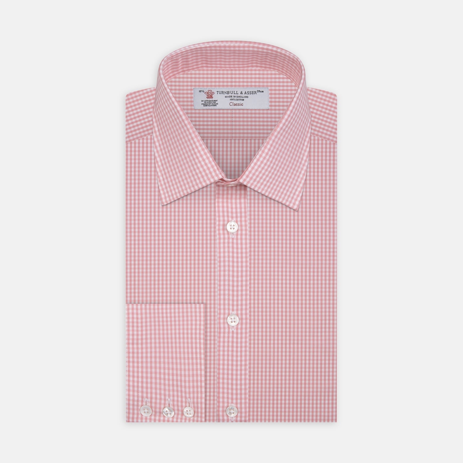 View 1 of product The Turnbull & Asser Light Pink Gingham Check Shirt features a classic T&A collar, 3-button cuffs, and white buttons, neatly folded on a plain white background.