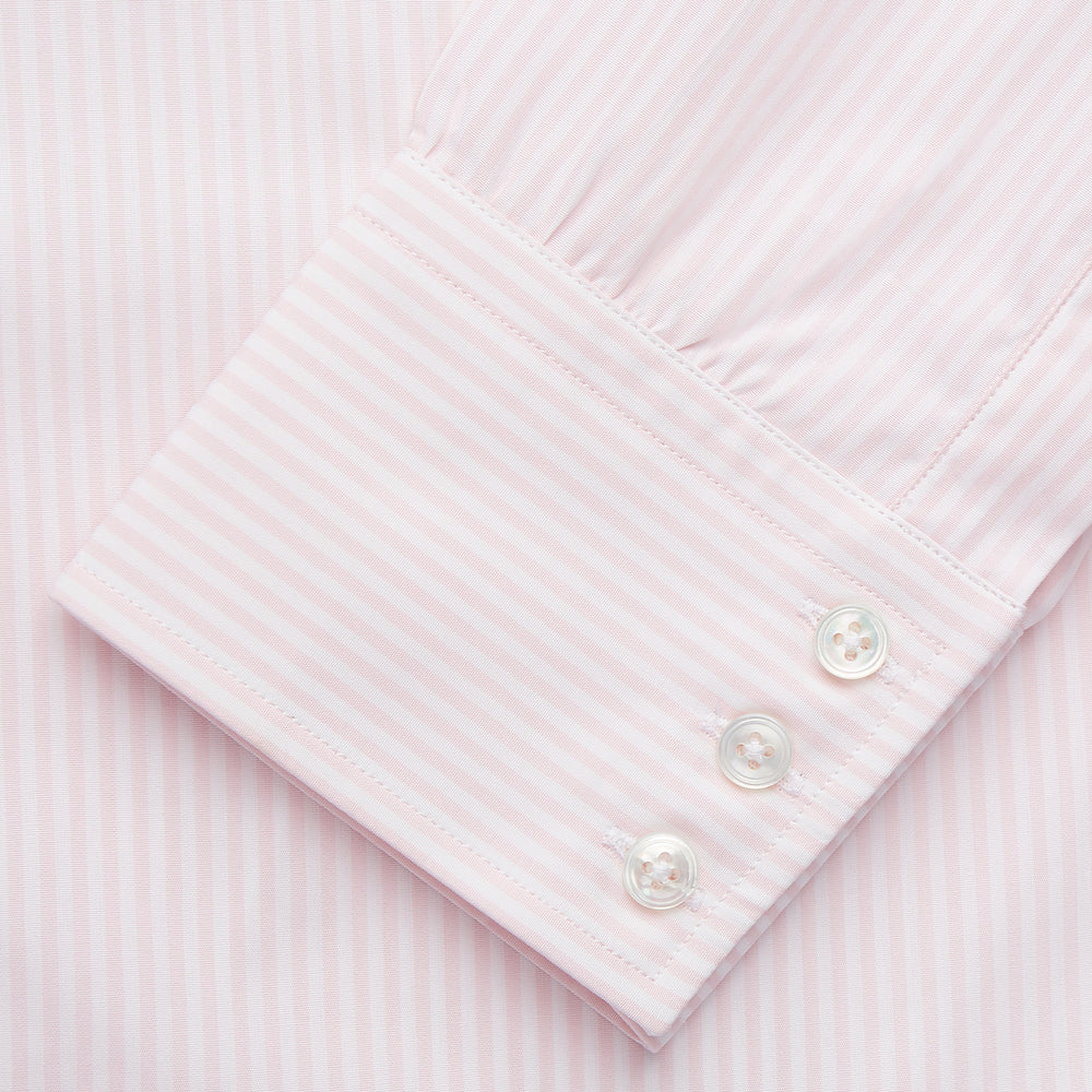The Turnbull & Asser White and Pink Wide Stripe Belgravia Shirt features long sleeves, a classic collar, buttoned cuffs, and a wide stripe pattern—an elegant men's formal shirt from the Belgravia collection.