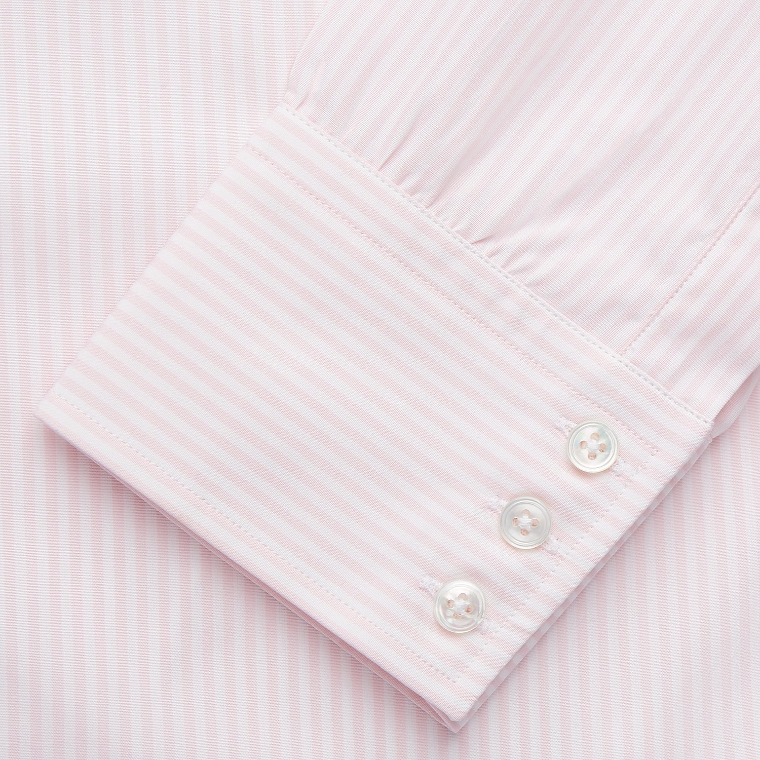 View 3 of product The Turnbull & Asser White and Pink Wide Stripe Belgravia Shirt features long sleeves, a classic collar, buttoned cuffs, and a wide stripe pattern—an elegant men's formal shirt from the Belgravia collection.