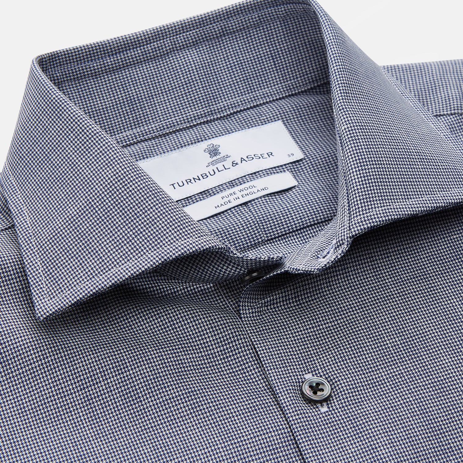 View 4 of product The Turnbull & Asser Navy Houndstooth Wool Tailored Fit Shelton Shirt features a classic collar, buttoned cuffs, and a refined tailored fit, shown laid flat on a white background.