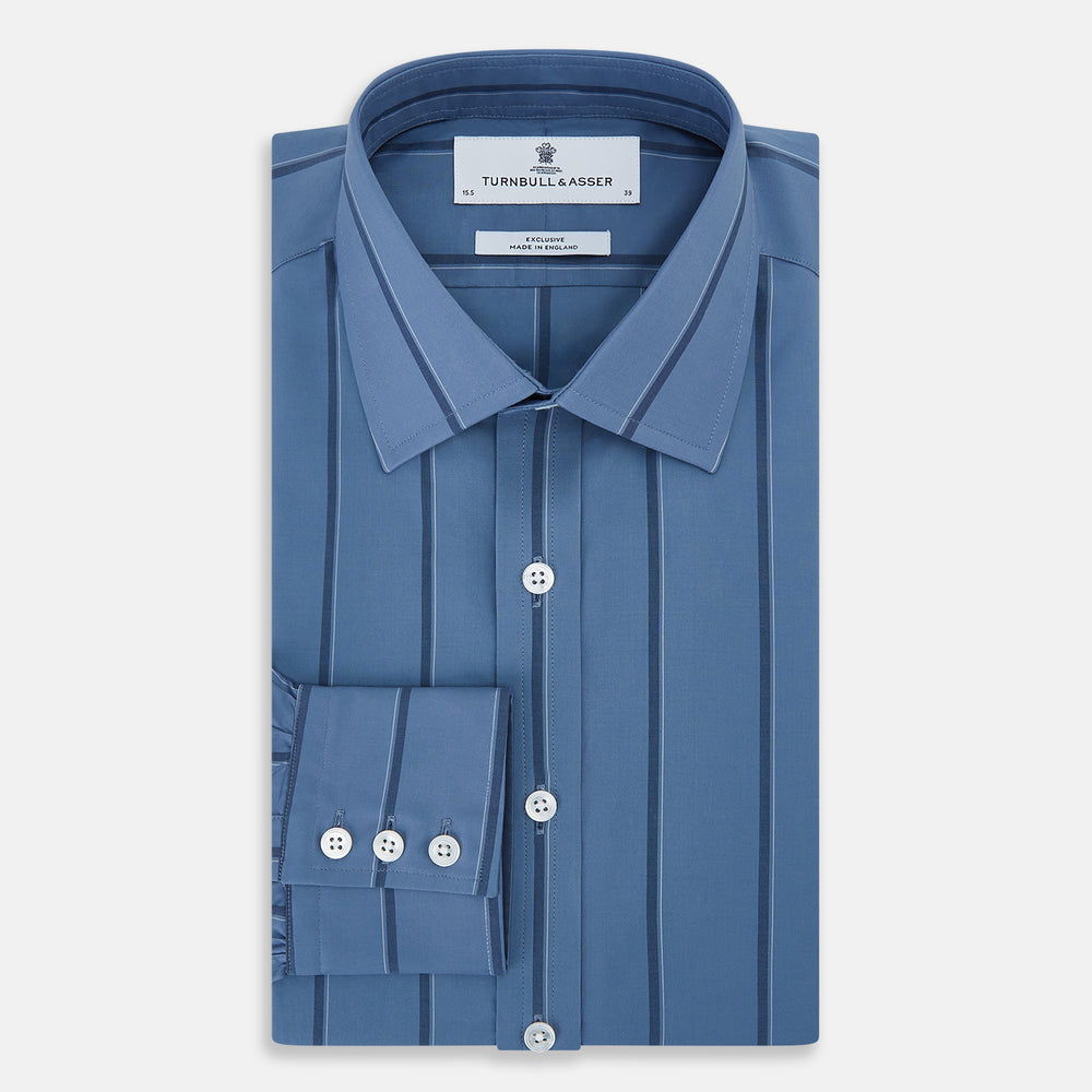 The Turnbull & Asser Steel Grey and Navy Track Stripe Mayfair Shirt features long sleeves, a collar, white buttons, and a relaxed fit, shown on a plain white background.