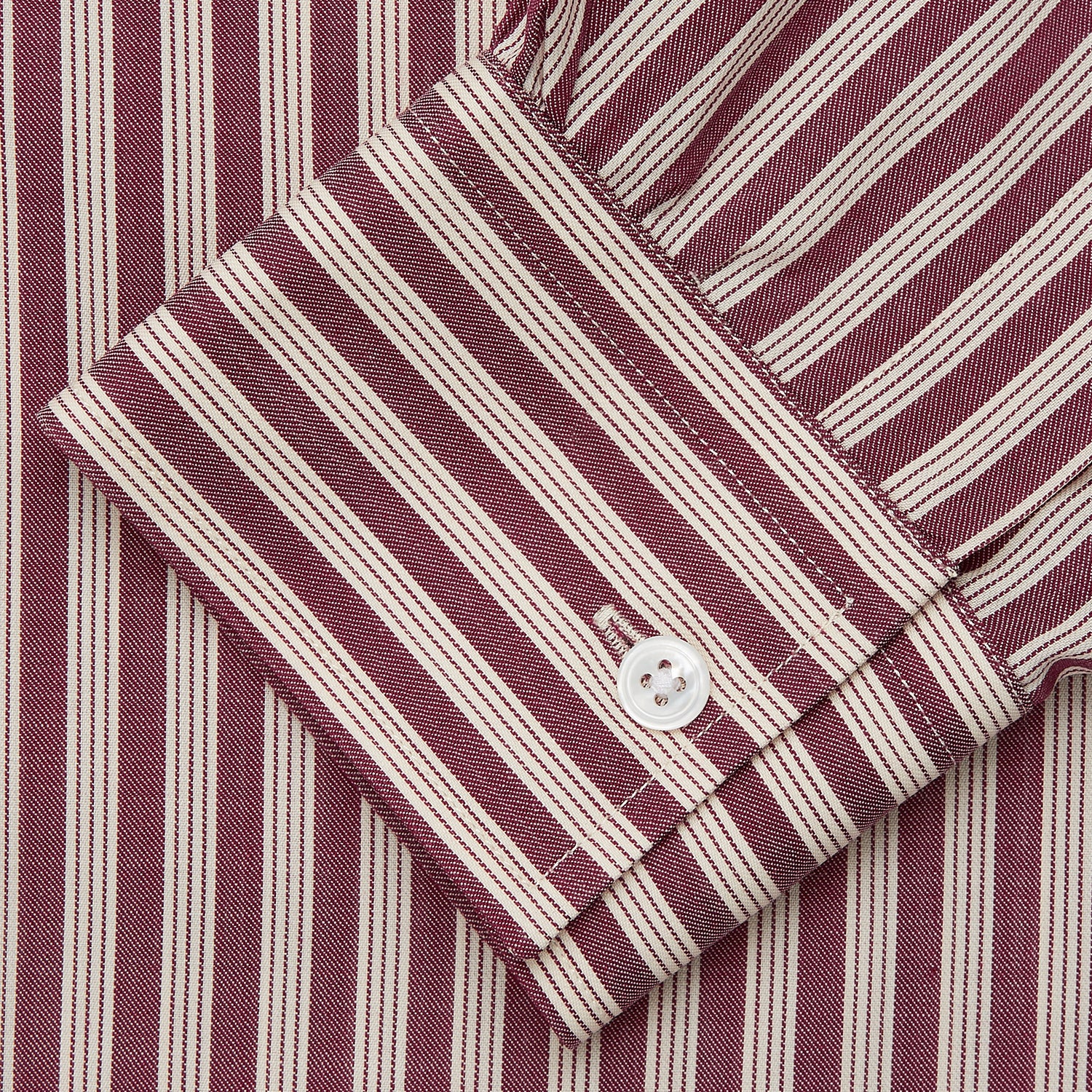 View 3 of product The Turnbull & Asser Burgundy Multi Stripe Weekend Fit Wool Shirt features a Derby collar, 1 button cuffs, and vertical red and white stripes, ideal for casual wear, shown against a white background.