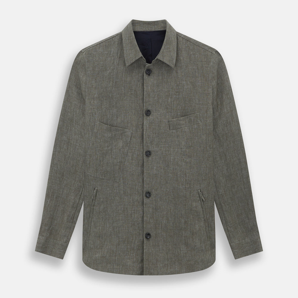 The Olive Linen Holland Shacket by Turnbull & Asser is a lightweight olive button-up jacket in Irish linen with a collar, two front pockets, one chest pocket, and slanted hem pockets—ideal outerwear shown on a plain white background.