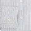 View 4 of product The Turnbull & Asser Pale Blue and Grey Grid Check Mayfair Shirt features long sleeves, a pointed collar, and buttoned cuffs. Crafted from Italian cotton, it displays a subtle grid pattern on a plain white background.