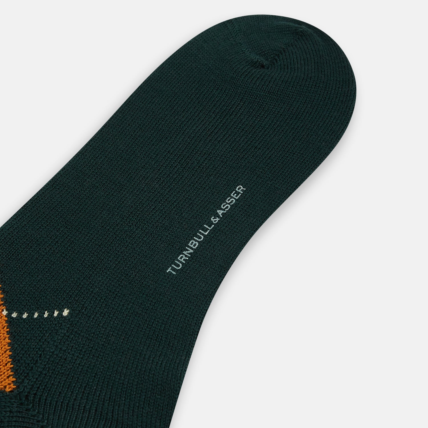 View 3 of product The Forest Green Wool Check Mid-Length Socks by Turnbull & Asser feature a dark green base with orange and brown argyle checks and white dotted lines, shown against a plain white background.
