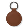 View 2 of product A tan circular leather fob holder by Turnbull & Asser, featuring visible stitching, embossed branding, and 'Made in England,' attached to a metal key ring.