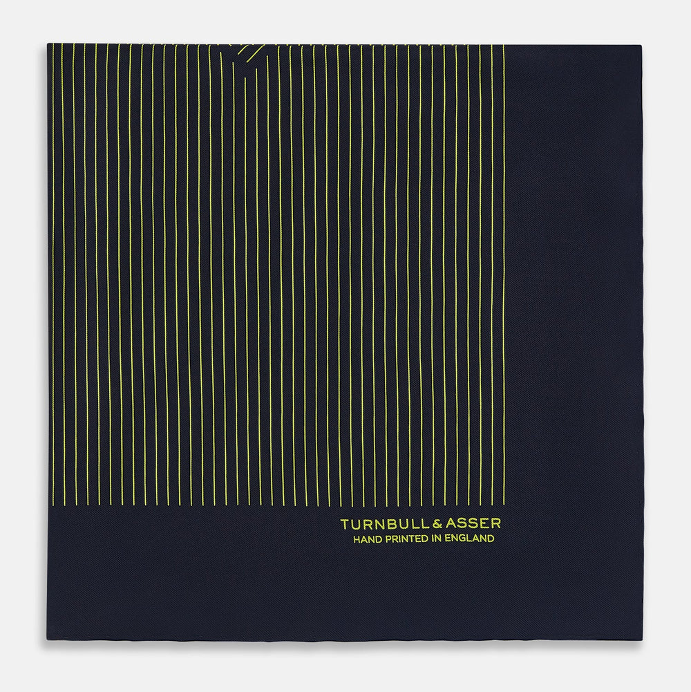 Turnbull & Asser Navy and Yellow Stripe Silk Pocket Square features hand-rolled edges, striped pattern, and "Turnbull & Asser Hand Printed in England" text in yellow on the bottom right corner.