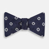 View 1 of product The Navy and White Motif Silk Bow Tie by Turnbull & Asser features a geometric floral pattern, adding refined elegance to formalwear. Shown on a plain white background.