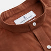 View 4 of product The Turnbull & Asser Rust Cotton Weekend Fit Blake Shirt features long sleeves, a stand collar, and white buttons—an ideal casual piece displayed flat on a white background.
