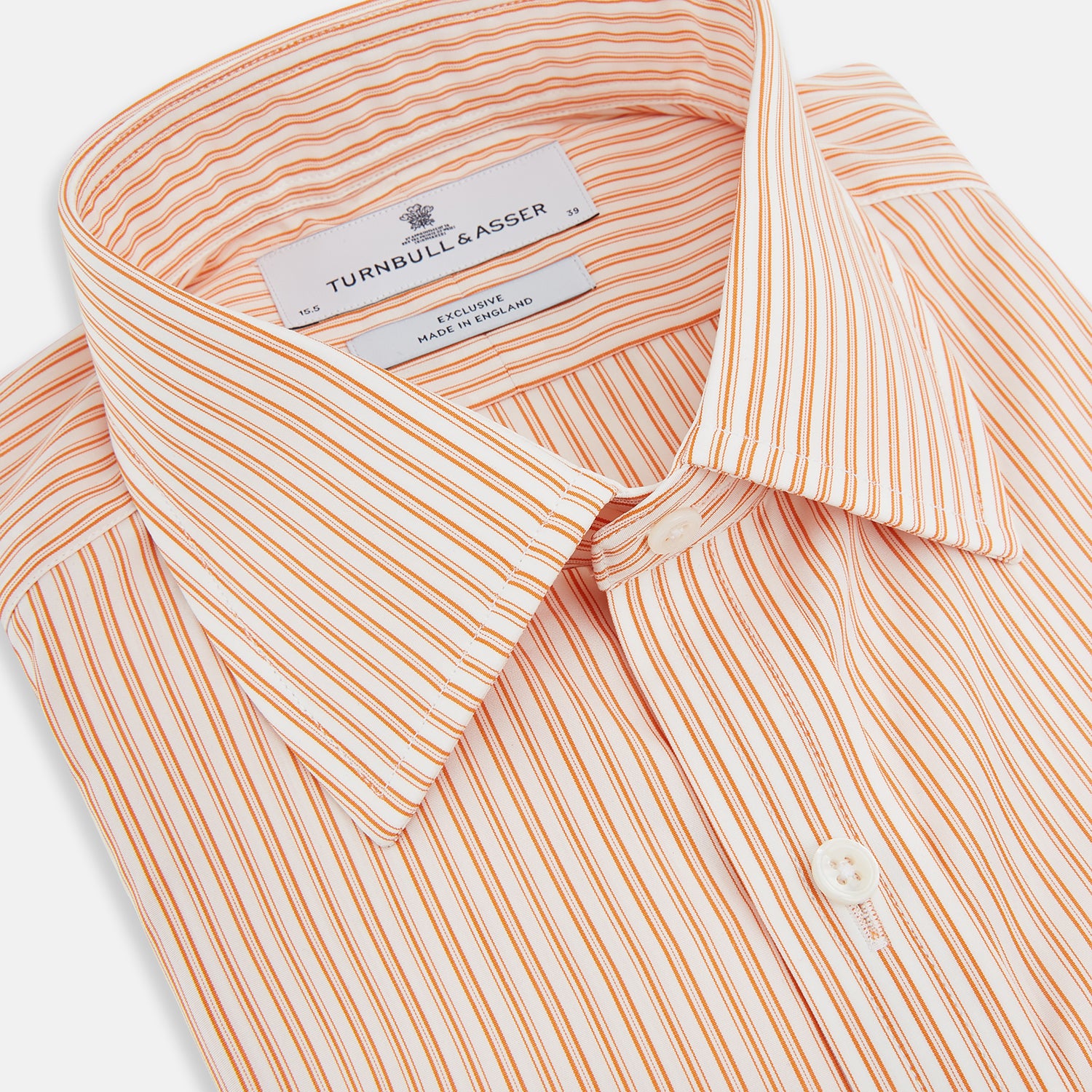 View 2 of product The Turnbull & Asser Orange Ticking Stripe Mayfair Shirt features thin vertical stripes, a classic T&A collar, and buttoned cuffs, shown on a plain white background.