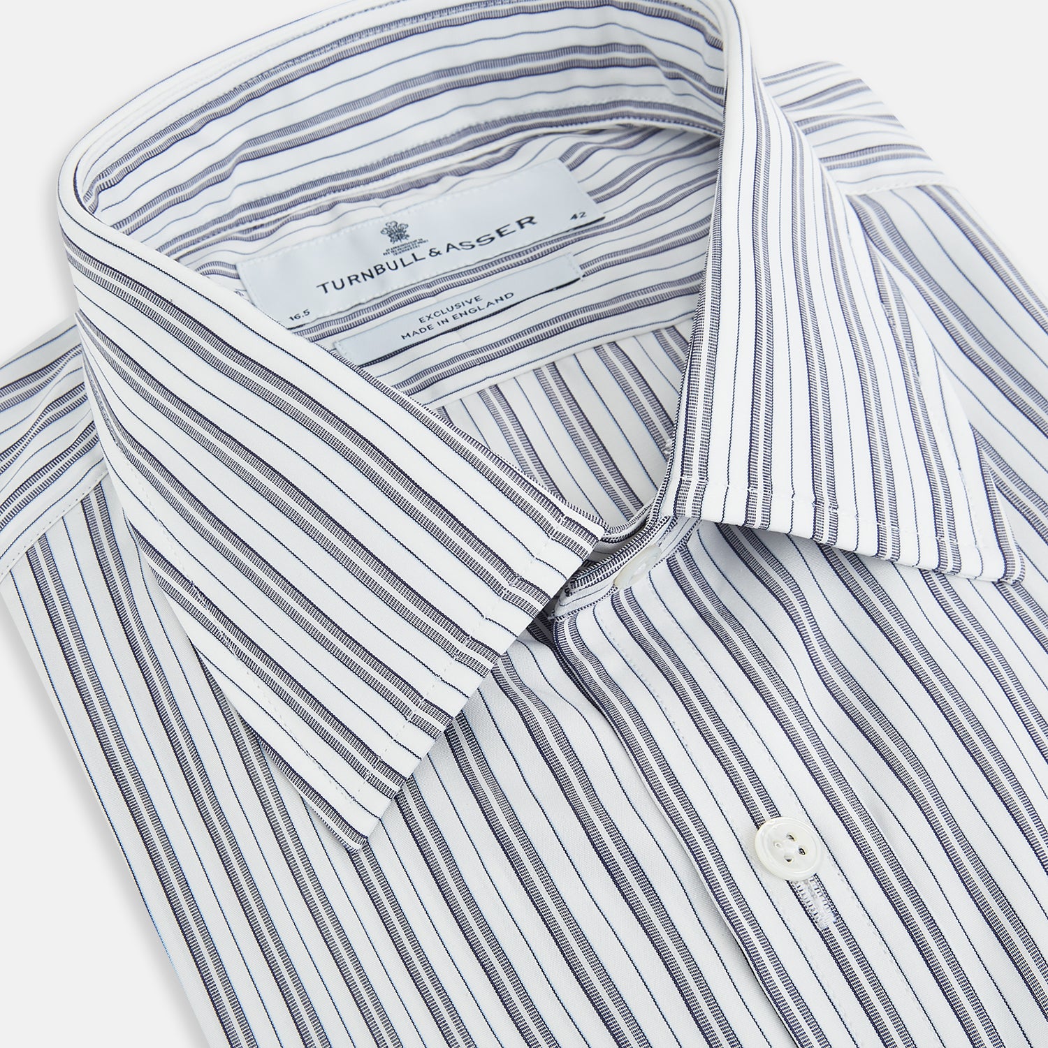 View 2 of product The Turnbull & Asser Navy Multi Stripe Mayfair Shirt, a pure cotton button-up with long sleeves and a collar, features thin vertical blue and white stripes and is displayed flat on a white background.