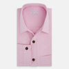 View 5 of product The Pink Hyde Overshirt by Turnbull & Asser is a long-sleeved, light pink sanforised cotton shirt with a left chest pocket and dark buttons—an elegant, laid-back alternative to a blazer.