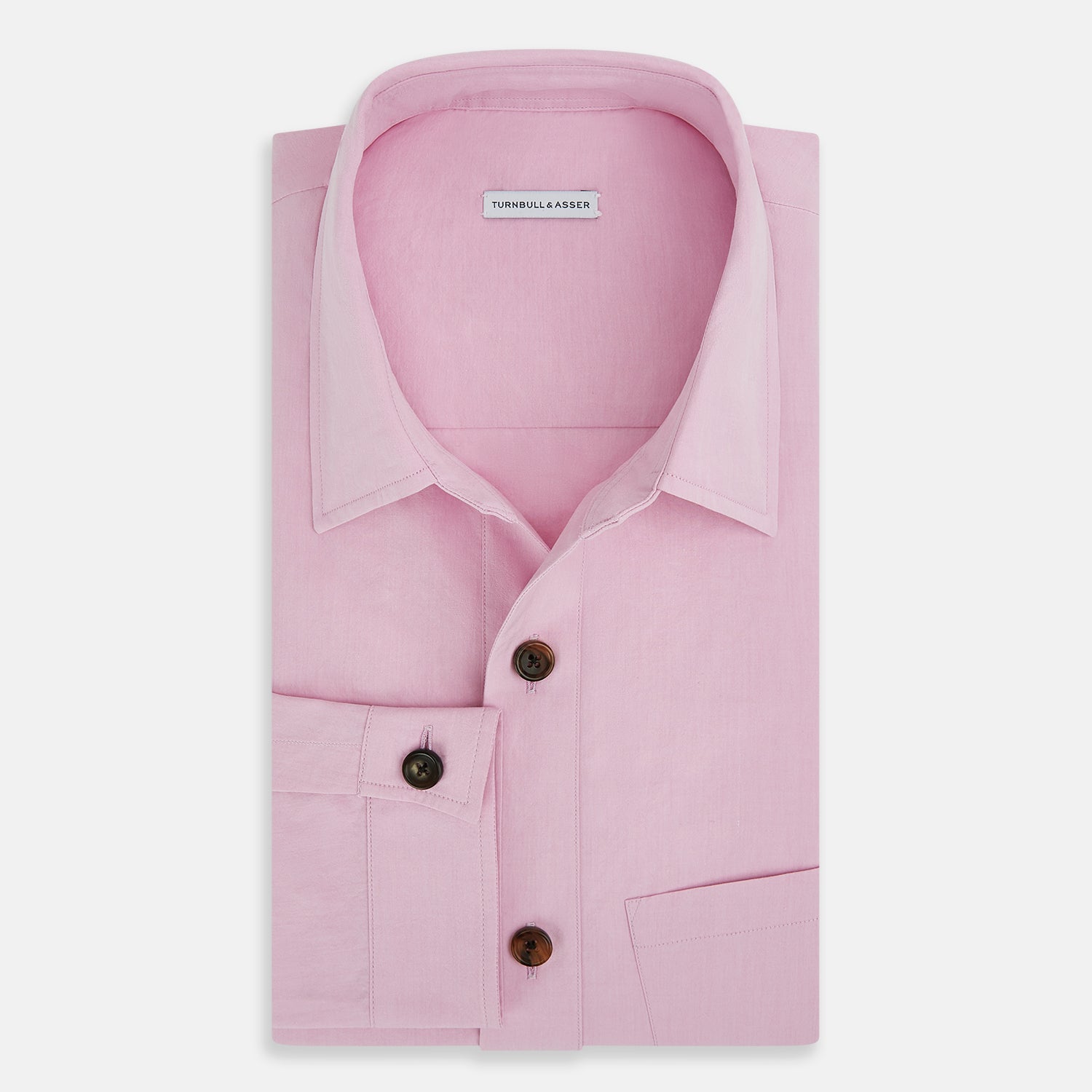 View 5 of product The Pink Hyde Overshirt by Turnbull & Asser is a long-sleeved, light pink sanforised cotton shirt with a left chest pocket and dark buttons—an elegant, laid-back alternative to a blazer.
