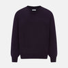 View 1 of product The Turnbull & Asser Dark Purple Fine Merino V-Neck Jumper features long sleeves and a classic knit, shown against a white background.