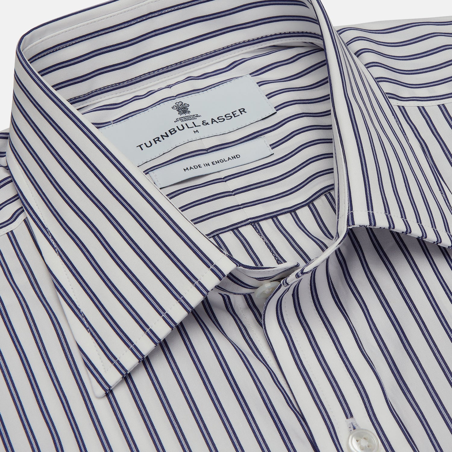 View 2 of product The Turnbull & Asser Navy Stripe Weekend Fit Shirt features a Derby collar, vertical navy and white stripes, 1-button cuffs, a chest pocket, and a regular fit, shown laid flat against a white background.