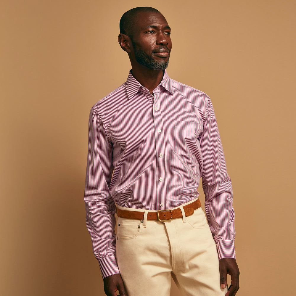 The Turnbull & Asser Purple & White Stripe Weekend Fit Shirt features a Derby collar, chest pocket, and 1-button cuffs—ideal for casual weekends.
