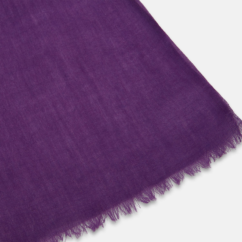 The Purple Cashmere Scarf by Turnbull & Asser is a luxurious, lightweight accessory, hand-dyed in purple with subtle frayed edges and a loose central knot, elegantly displayed on a plain white background.
