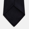 View 4 of product The Turnbull & Asser Midnight Blue Knitted Tie, elegantly textured and displayed on a white background, is a versatile addition to any gentleman's wardrobe.