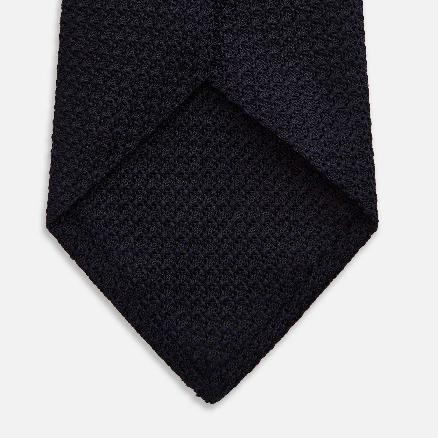 View 4 of product The Turnbull & Asser Midnight Blue Knitted Tie, elegantly textured and displayed on a white background, is a versatile addition to any gentleman's wardrobe.