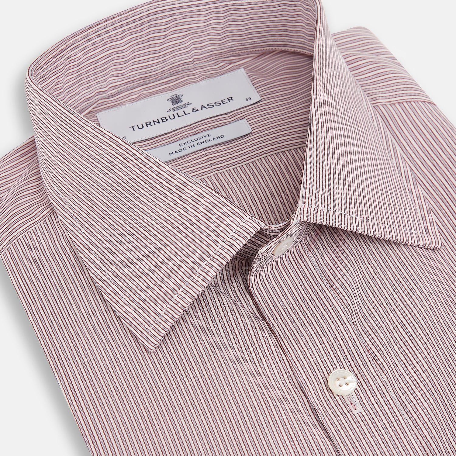 View 2 of product A Red and Pink Ticking Stripe Mayfair Shirt by Turnbull & Asser, featuring a classic T&A collar, buttoned cuffs, and subtle vertical pinstripes, shown on a white background.
