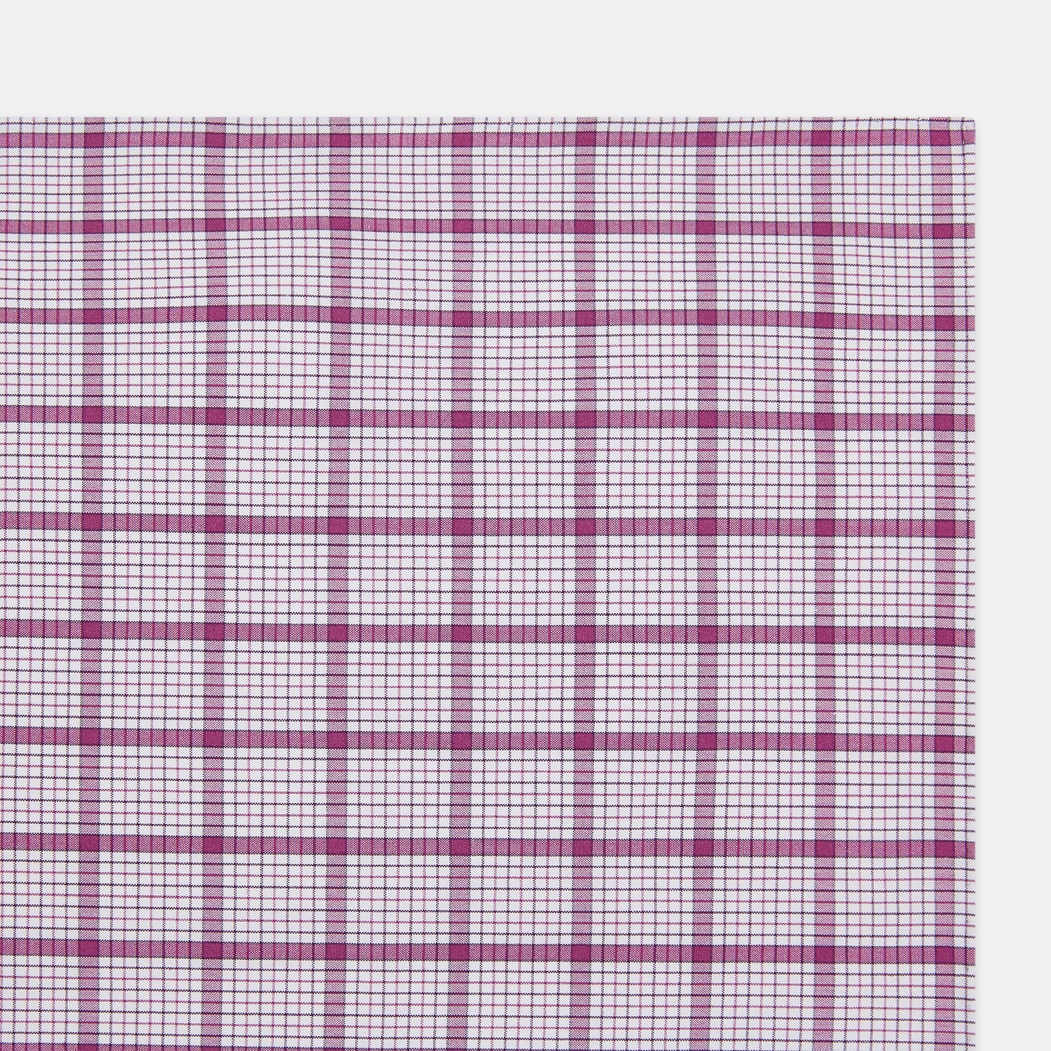 View 2 of product The Turnbull & Asser Hand Rolled Purple Graph Overlay Check Handkerchief is a white cotton accessory featuring intersecting purple and pink lines that create evenly spaced squares across the fabric.