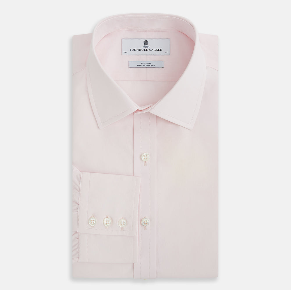 The Soft Pink Mayfair Shirt by Turnbull & Asser is a long-sleeved, sanforised cotton button-up with a classic collar, white buttons, and buttoned cuffs, shown against a plain white background.
